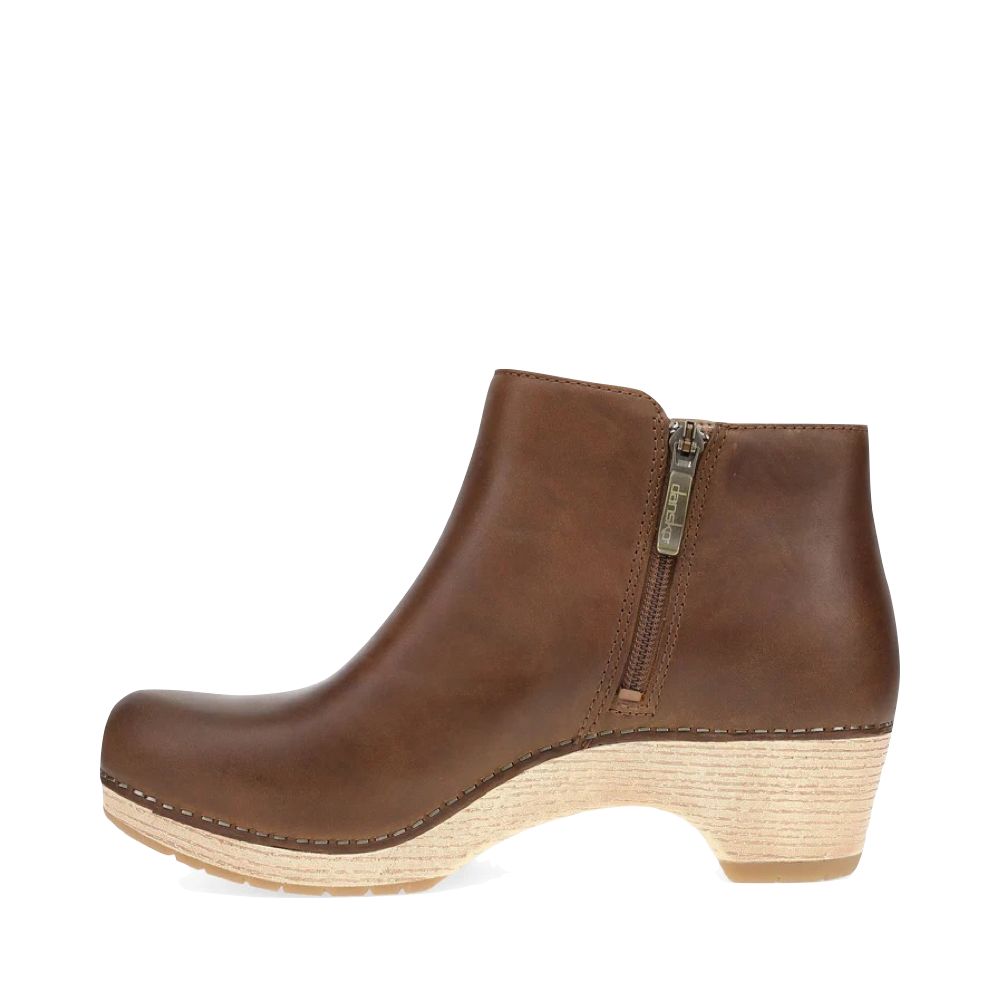 Side (left) view of Dansko Lizanne Heeled Oiled Leather Boot for women.