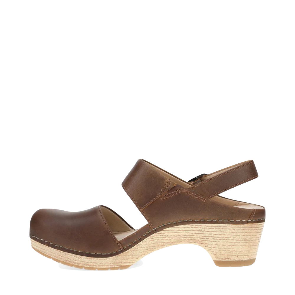 Side (left) view of Dansko Lucia Heeled Closed Toe Clog for women.