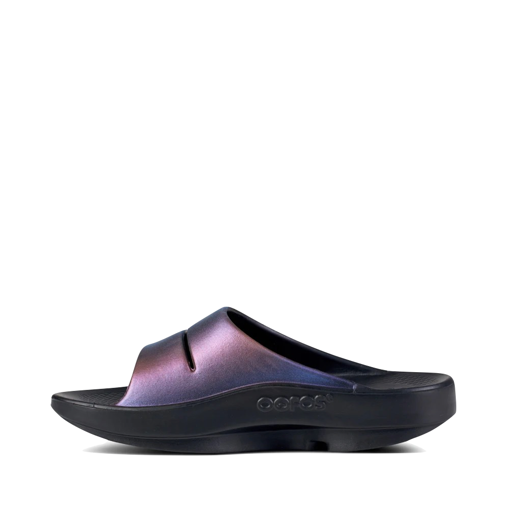 Side (left) view of OOfos OOahh Luxe Slide Sandal for women.
