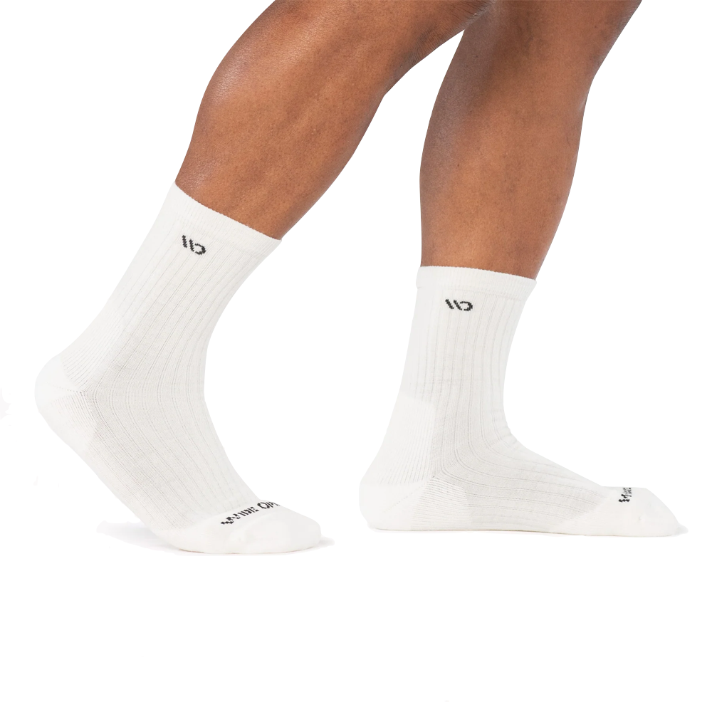 Side Model view of Wide Open by Darn Tough Solid Cushioned Micro Crew Socks for men.