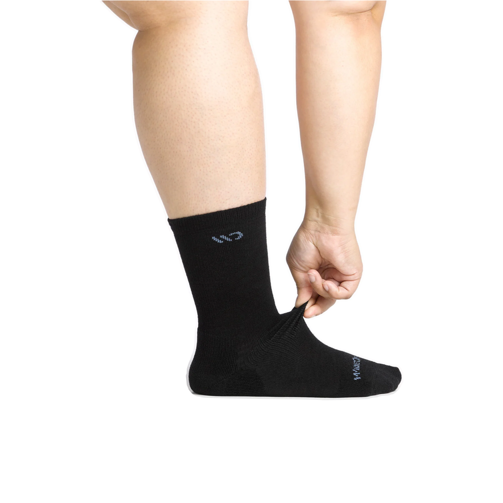 Model side view of Wide Open by Darn Tough Solid Cushioned Crew Socks for women.