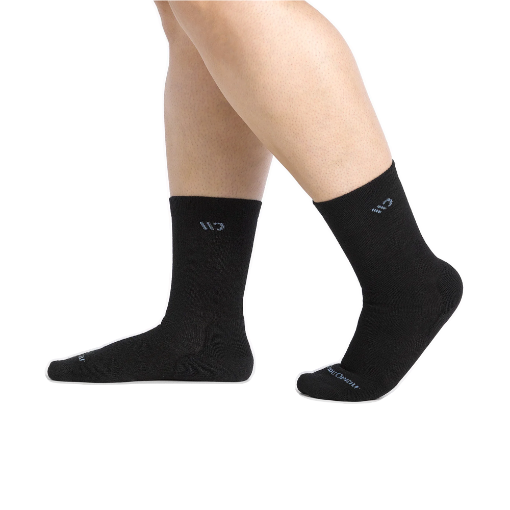 Model (side) view of Wide Open by Darn Tough Solid Cushioned Crew Socks for women.