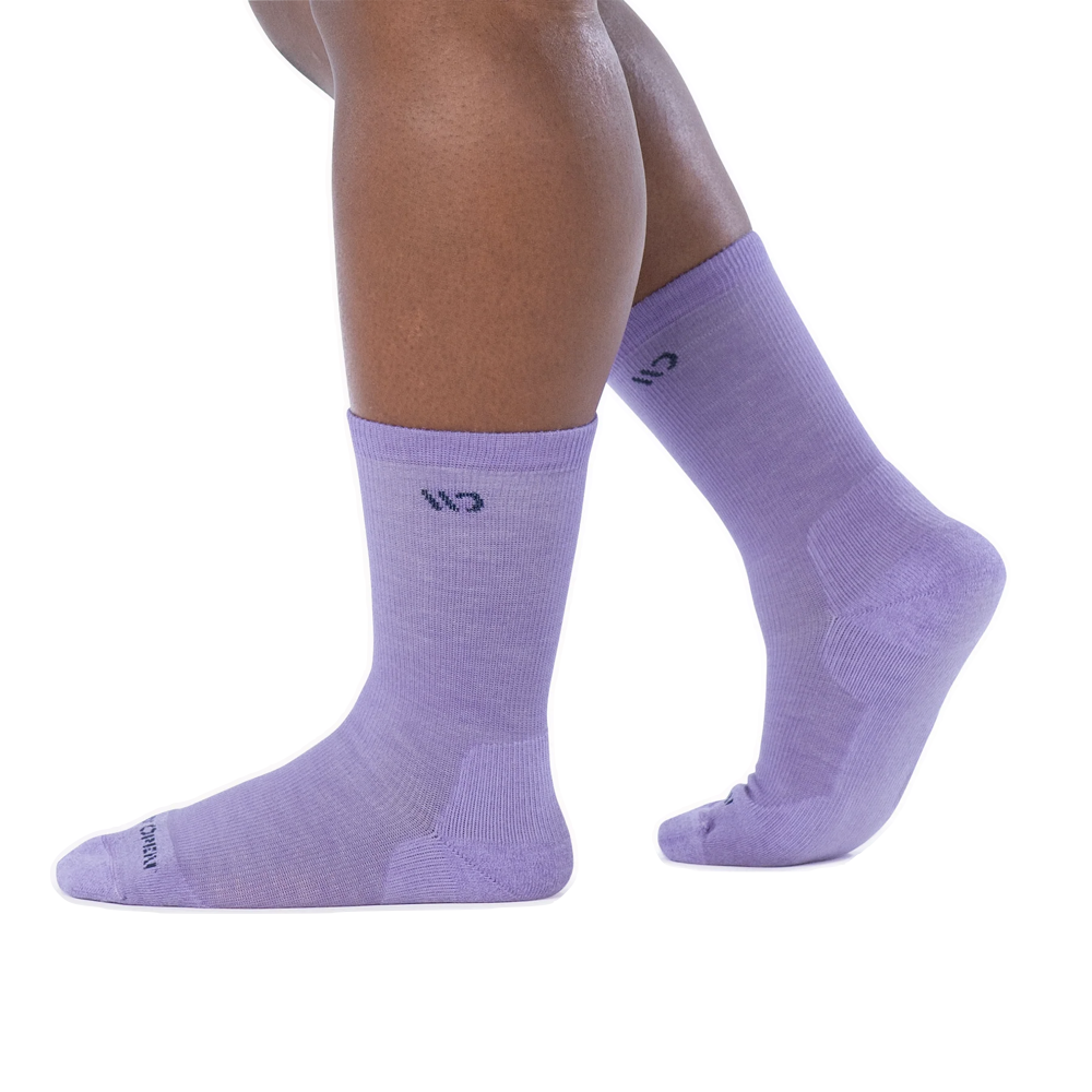 Side model view of Wide Open by Darn Tough Solid Cushioned Crew Socks for women.