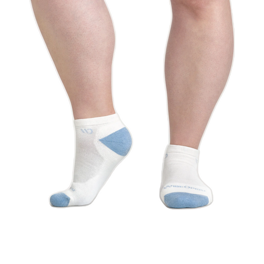 Model view of Wide Open by Darn Tough Solid Cushioned No Show Socks for women.